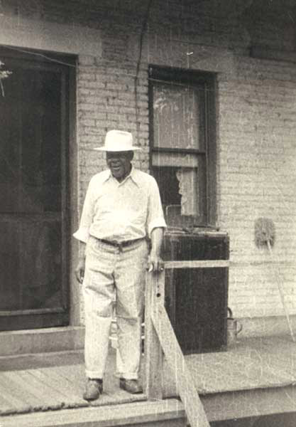Albert Dunham Sr. (father) on porch, n.d.