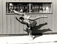 Anne Walker and Darryl Braddix, Performing Arts Training Center (PATC) dancers, in front of Pudgey's Lounge, East St. Louis, Illinois, ca. 1975.